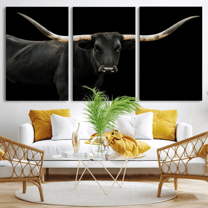 Close-up of a black Texas longhorn with large curved horns on black background, ideal for rustic farmhouse or modern western interiors.