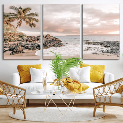 A peaceful beach scene with a palm tree and rocks, soft waves washing onto the shore under a soft pastel sky at sunset.