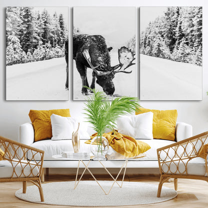A majestic moose grazing in the snow-covered wilderness, surrounded by snow-covered trees, creating a peaceful winter scene.