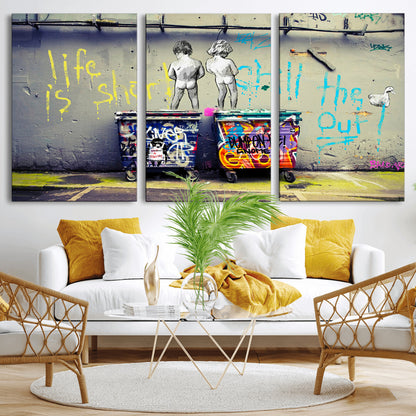 Graffiti-style canvas art with bold text and two naked figures over urban dumpsters, ideal for edgy or street-style decor.