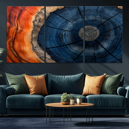 A captivating close-up of a tree trunk, showcasing its concentric rings in rich shades of blue, orange, and brown, highlighting the organic patterns of natural wood.