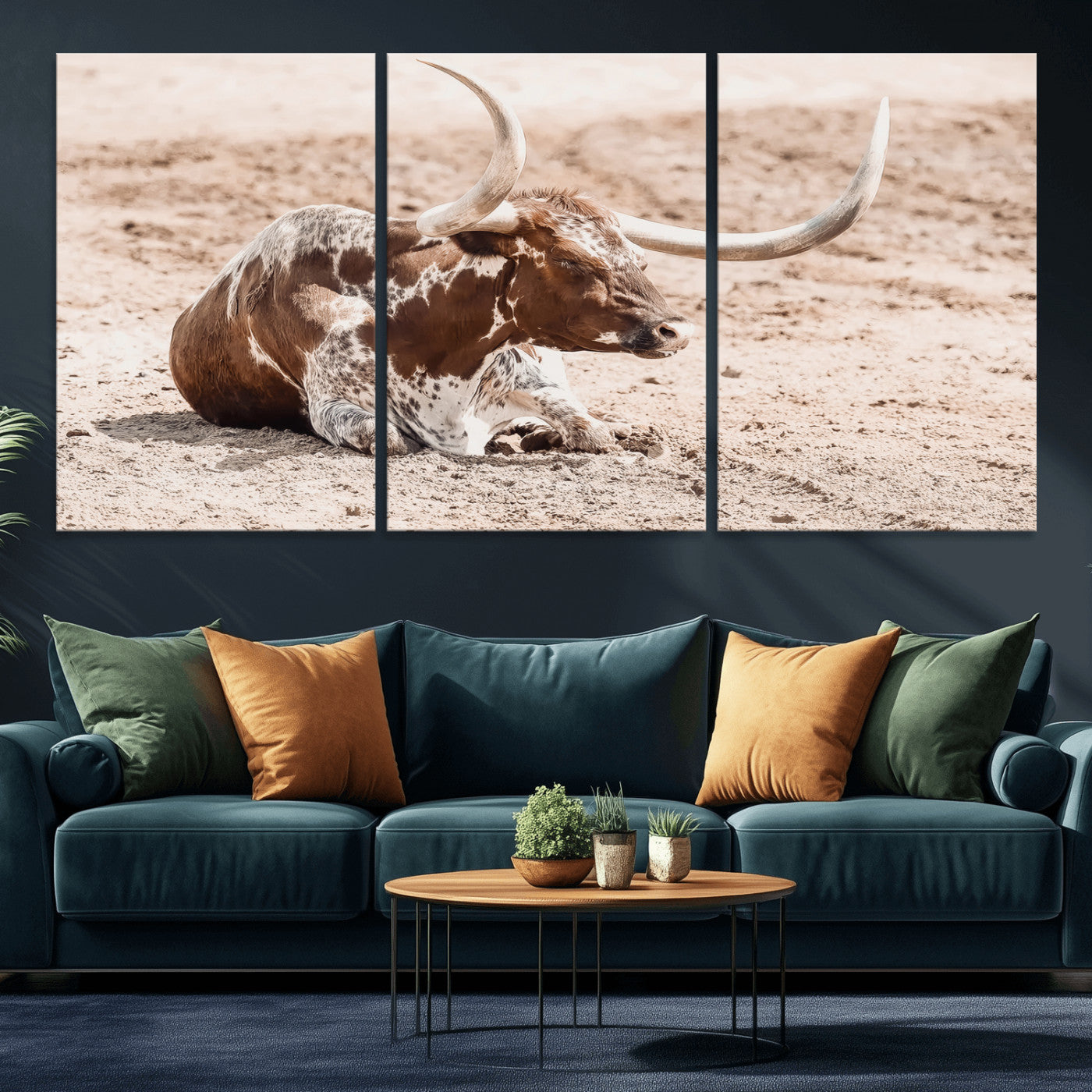 Texas Longhorn bull resting on dusty ground with warm tones, ideal for rustic western or farmhouse-themed wall decor.
