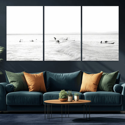 Monochrome photo of surfers riding and waiting on ocean waves, ideal for surf-themed or coastal energy wall decor.