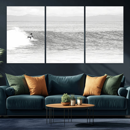 Monochrome photo of a surfer riding a wave with distant mountains, ideal for coastal motion or black and white surf-themed wall decor.
