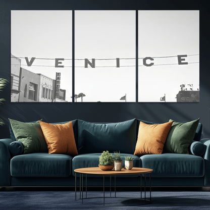 Black and white photo of Venice Beach sign and palm-lined street, perfect for urban coastal or minimalist LA-inspired wall decoration.