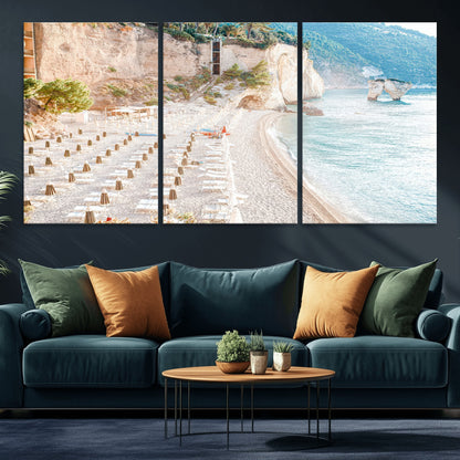 Wall art of a calm Mediterranean beach with rows of sun loungers and umbrellas in soft pastel tones, perfect for light coastal or vacation-themed decor.