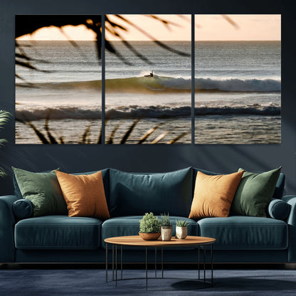Photo of a surfer riding a golden hour wave at sunset, with tropical tones and dreamy light, perfect for tropical boho or coastal home decor.