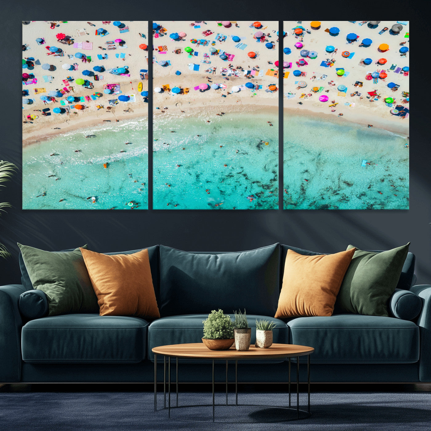 Aerial view of a vibrant beach filled with colorful umbrellas and people enjoying the turquoise ocean, capturing a lively summer vacation scene.