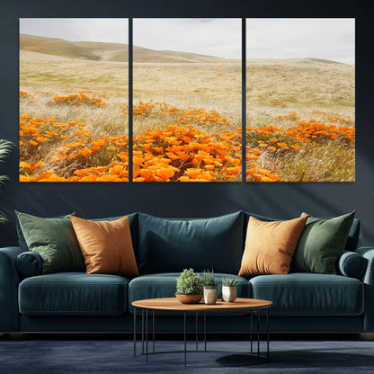 A golden field with vibrant orange poppies blooming across rolling hills under a soft, sunlit sky, creating a warm and rustic landscape.