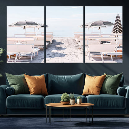 A serene minimalist beach scene featuring striped umbrellas, soft pastel sand, and an elegant lounge setup, creating a tranquil and stylish coastal retreat.