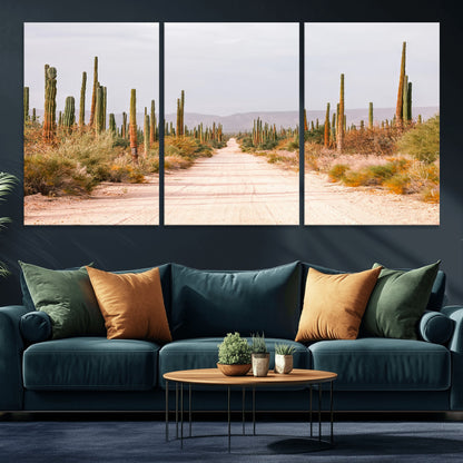 A desert road lined with saguaro cacti under a golden sky, creating a warm southwestern feel, perfect for boho or rustic decor.