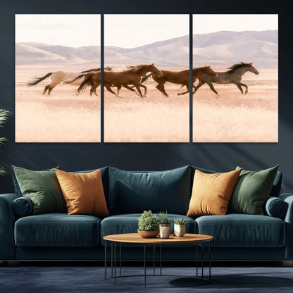 A herd of wild horses galloping through a sunlit desert plain with mountains in the background, perfect for rustic or western-themed wall decor.