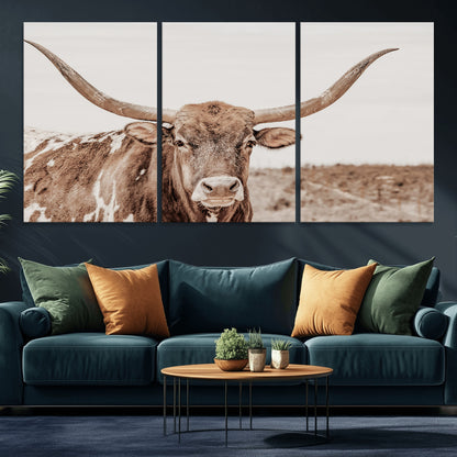 A longhorn cow in soft beige desert tones, standing calmly in open land, perfect for neutral western or rustic farmhouse interiors.