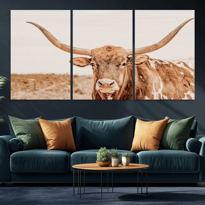 A longhorn bull standing proudly in a sunlit desert field with warm neutral tones, ideal for rustic western or farmhouse interiors.