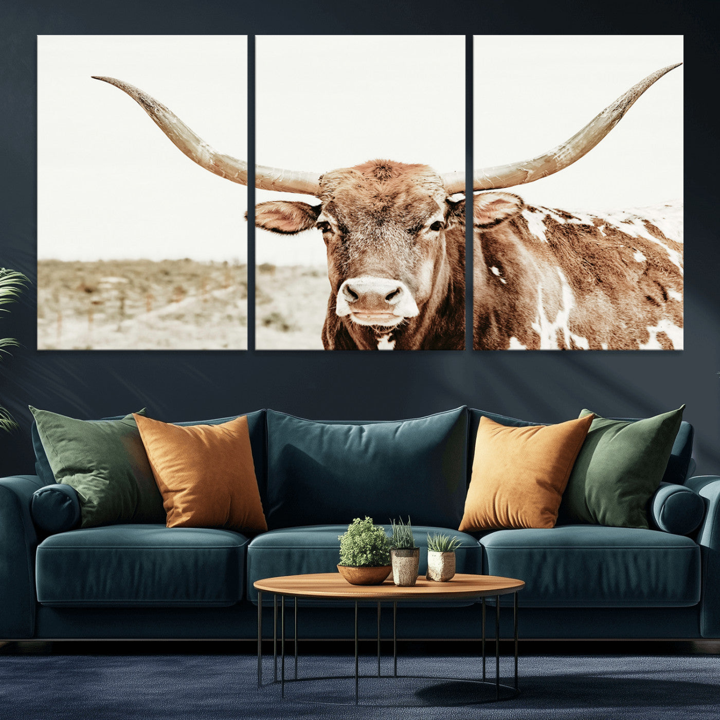A Texas longhorn bull with wide horns, standing in a dry field under soft light, ideal for rustic farmhouse or western-themed interiors.