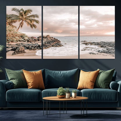 A peaceful beach scene with a palm tree and rocks, soft waves washing onto the shore under a soft pastel sky at sunset.
