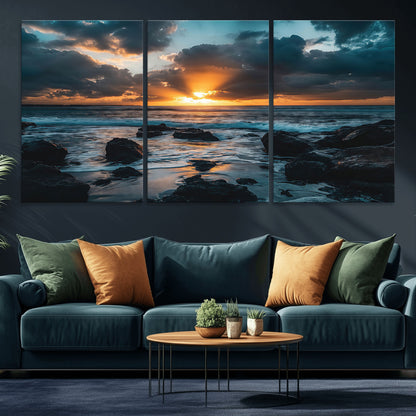 An awe-inspiring sunset over the ocean with rays of light piercing through dramatic clouds, creating a beautiful seascape with rocks in the foreground.