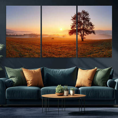 A tranquil landscape at sunrise with a mist-covered field and a lone tree, creating a peaceful and natural atmosphere.