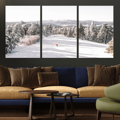 Bright ski trail lined with snow-covered pines and a skier in orange, perfect for alpine adventure or winter sports-inspired decor.