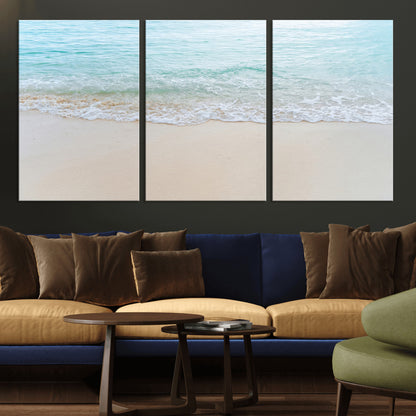 Soft shoreline with gentle aqua waves on smooth sand, ideal for minimalist coastal or pastel ocean-inspired home wall decor.