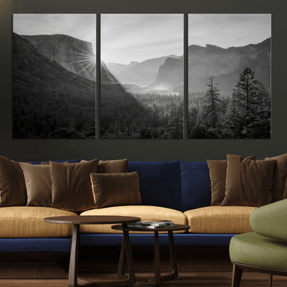 Black and white landscape of Yosemite with sun rays peeking over El Capitan, ideal for moody nature or modern rustic decor.