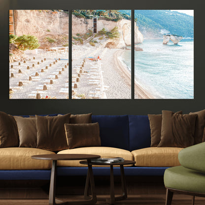 Wall art of a calm Mediterranean beach with rows of sun loungers and umbrellas in soft pastel tones, perfect for light coastal or vacation-themed decor.