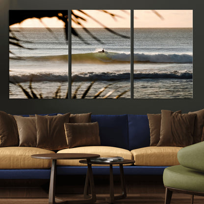 Photo of a surfer riding a golden hour wave at sunset, with tropical tones and dreamy light, perfect for tropical boho or coastal home decor.
