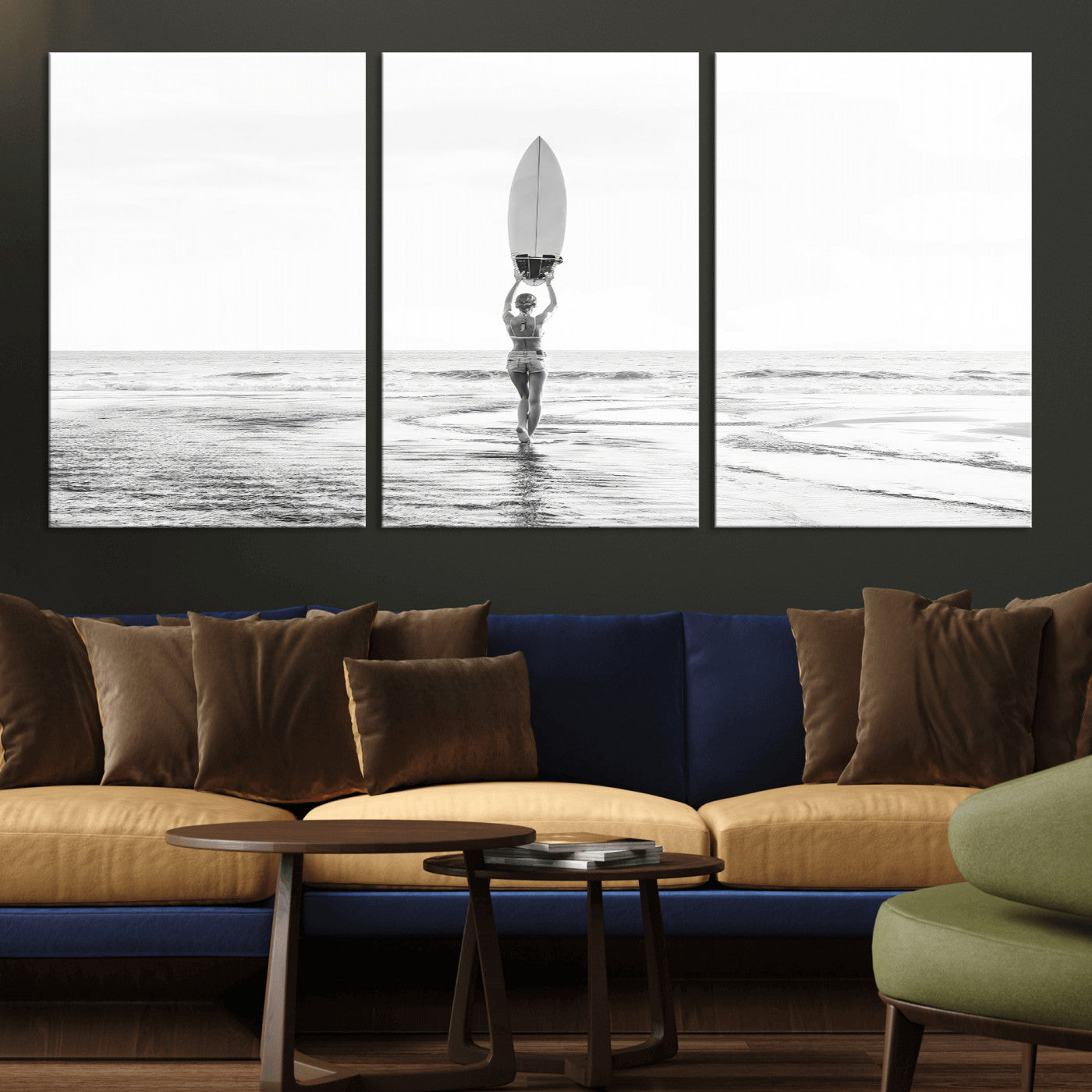 Black and white image of a female surfer holding a surfboard above her head while walking toward the ocean, creating a minimalist and bold coastal aesthetic.