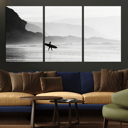 A lone surfer walking along a misty beach with cliffs in the background, carrying their board, capturing a serene and minimal ocean moment.