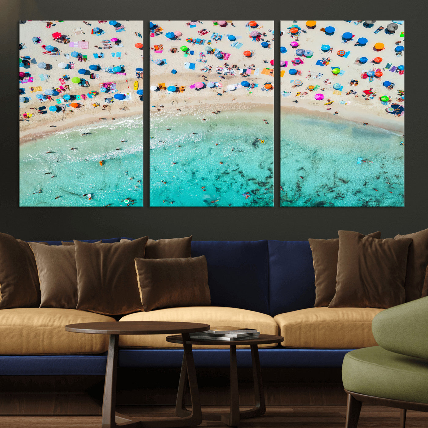 Aerial view of a vibrant beach filled with colorful umbrellas and people enjoying the turquoise ocean, capturing a lively summer vacation scene.