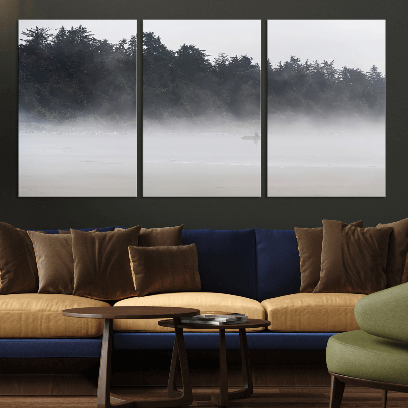 A lone surfer carrying a board through a misty shoreline, surrounded by dense trees and fog, creating a peaceful and mysterious coastal scene.