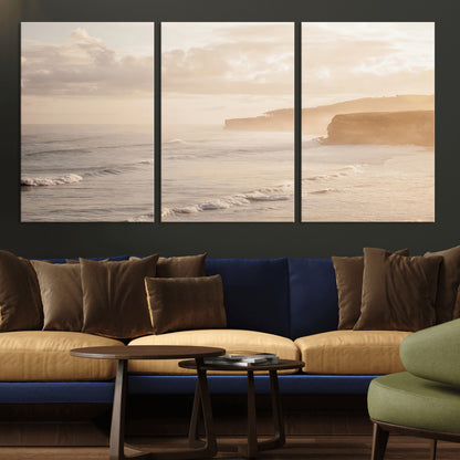 Golden hour seascape with misty cliffs and gentle waves rolling towards the shore, capturing a tranquil and warm coastal atmosphere.