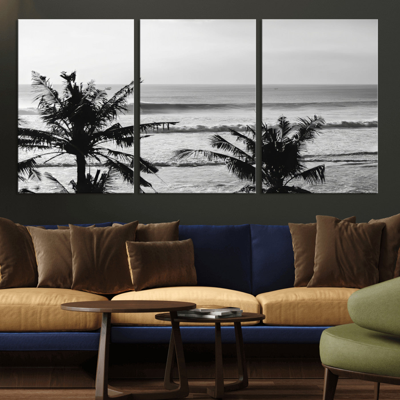 Black and white view of ocean waves crashing on a tropical coastline, framed by silhouetted palm trees under a vast, open sky.