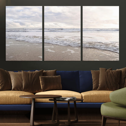 Peaceful ocean waves rolling onto the sandy shore under soft light, perfect for neutral or coastal minimalist decor themes.