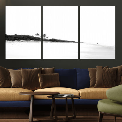 A black and white minimalist coastal scene with a vast open beach, distant palm trees, and a lone figure walking along the shoreline, evoking serenity and solitude.