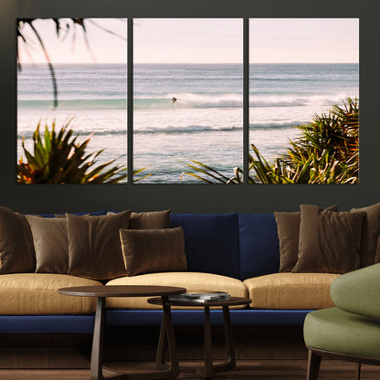 Canvas of a lone surfer riding a pastel wave at sunrise, perfect for tropical or coastal-themed spaces with a relaxed, airy vibe.