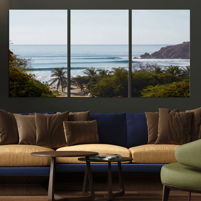 View of calm ocean waves with palm trees and a tropical coastline, ideal for coastal boho or beach-themed wall decor.