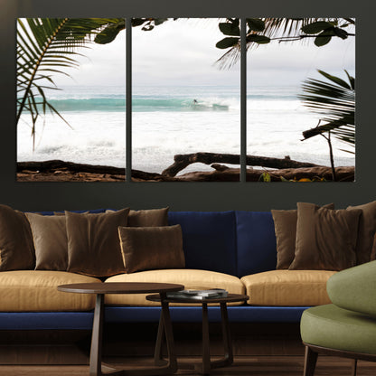 Tropical beach view with palm trees and surfer riding a wave, perfect for boho or coastal-inspired interior wall decor.