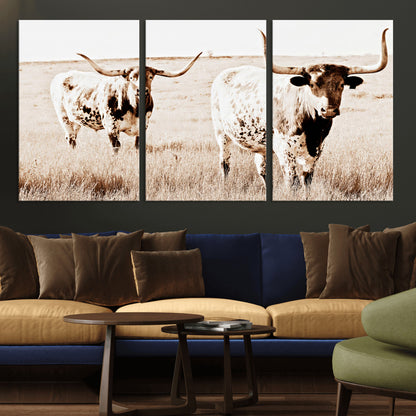 Two Texas longhorn cows standing in a sepia-toned pasture, evoking rustic charm perfect for farmhouse or western country interiors. (