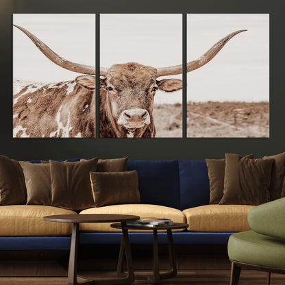 A longhorn cow in soft beige desert tones, standing calmly in open land, perfect for neutral western or rustic farmhouse interiors.