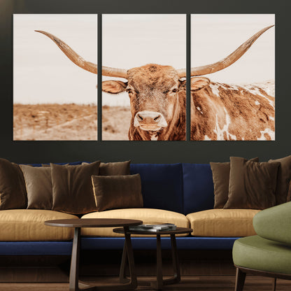 A longhorn bull standing proudly in a sunlit desert field with warm neutral tones, ideal for rustic western or farmhouse interiors.