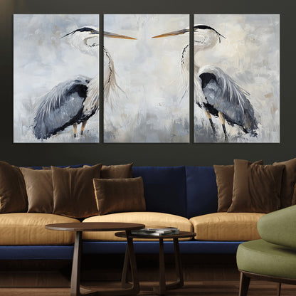 Two herons facing each other on a soft-toned background with blue-grey feathers, perfect for tranquil, coastal or nature-themed interiors.