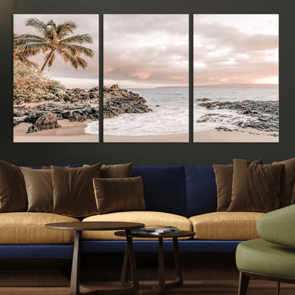 A peaceful beach scene with a palm tree and rocks, soft waves washing onto the shore under a soft pastel sky at sunset.