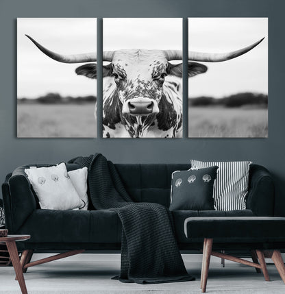 Capture the strength and elegance of nature with this striking black and white portrait of a longhorn cow. Its powerful presence makes a bold statement in any room.