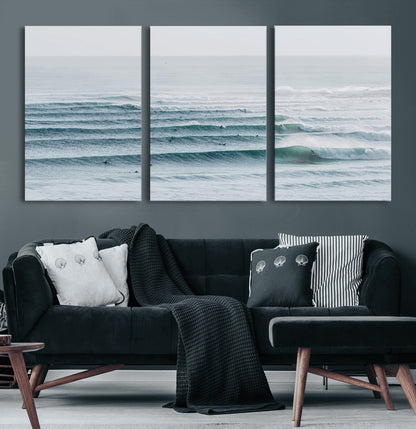 High-angle view of surfers lining up across layered ocean waves, ideal for minimal coastal or surf-inspired room decor.