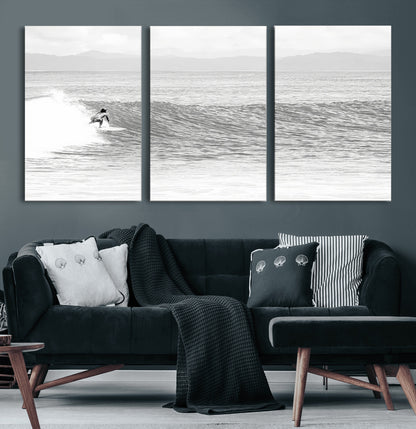 Monochrome photo of a surfer riding a wave with distant mountains, ideal for coastal motion or black and white surf-themed wall decor.