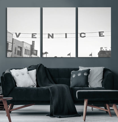 Black and white photo of Venice Beach sign and palm-lined street, perfect for urban coastal or minimalist LA-inspired wall decoration.