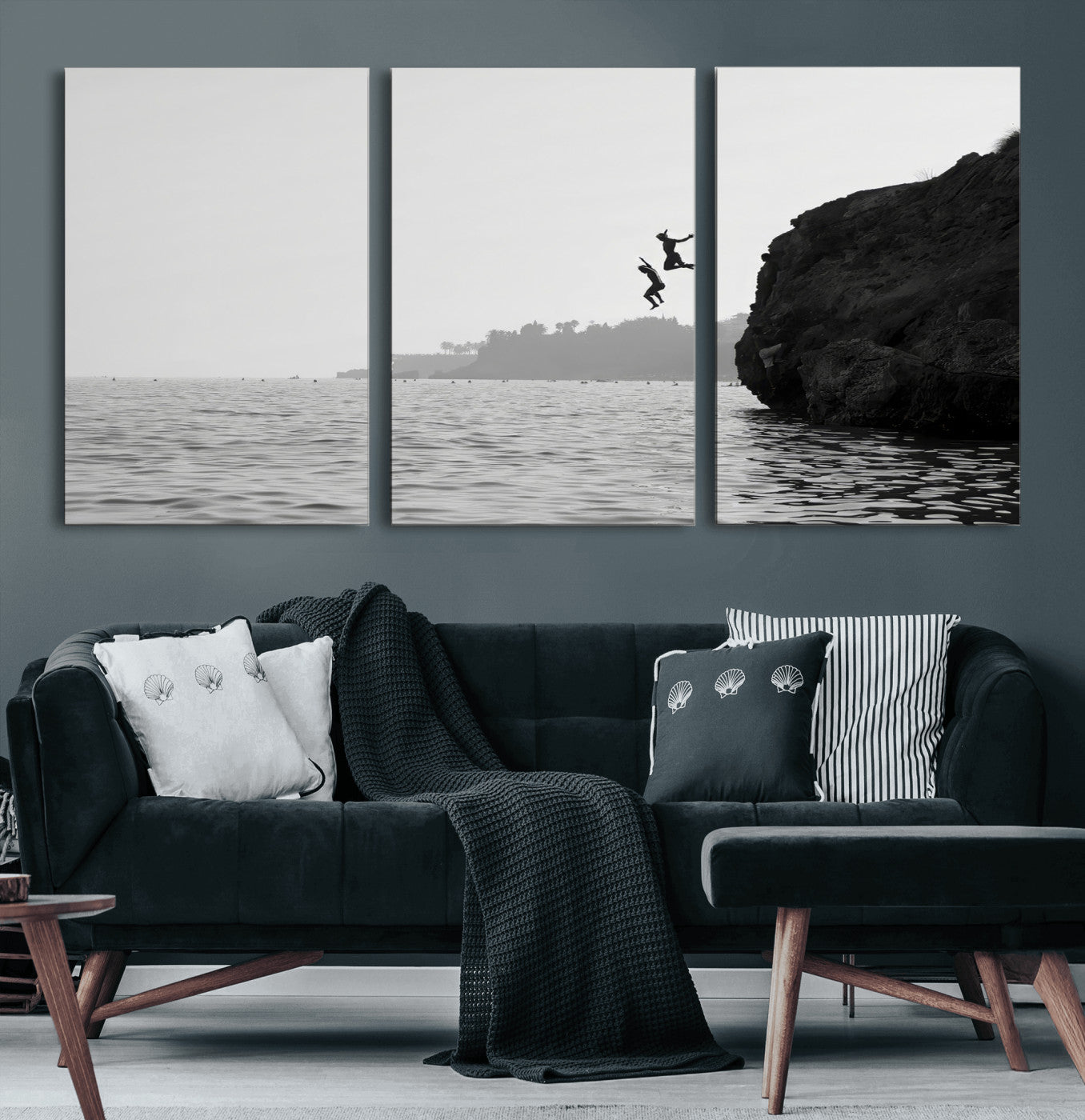 Black and white canvas of two figures cliff jumping into the sea, captured with moody tones, ideal for modern coastal or adventure-themed home decor.   2/2