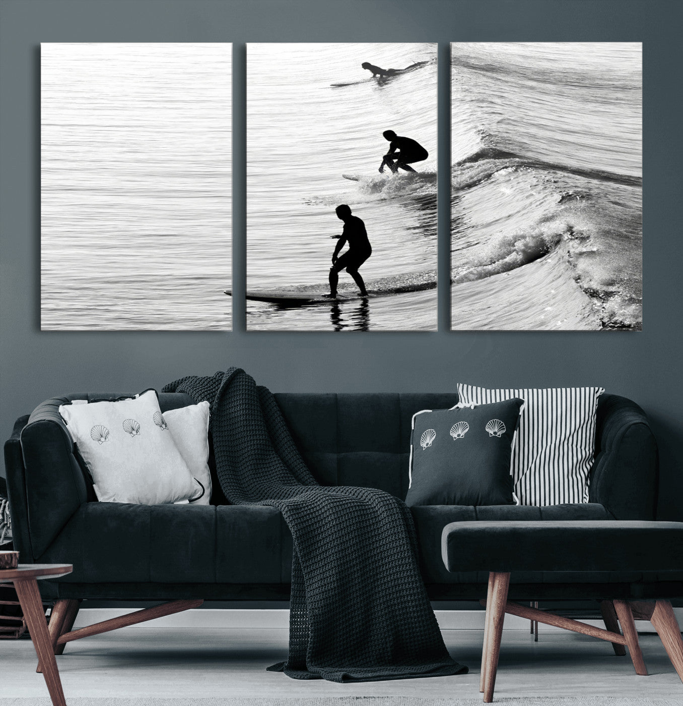 Black and white photo of surfers riding waves in a moody, high-contrast scene, ideal for modern coastal or surf-inspired home decor.