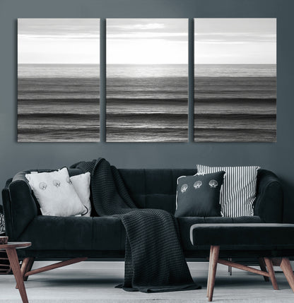 Minimalist black and white ocean view with layered waves reflecting sunlight, evoking a sense of calm and coastal serenity.
